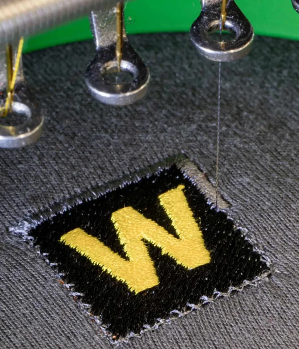 Industrial embroidery machine stitching company logo onto workwear — embroidery Watford